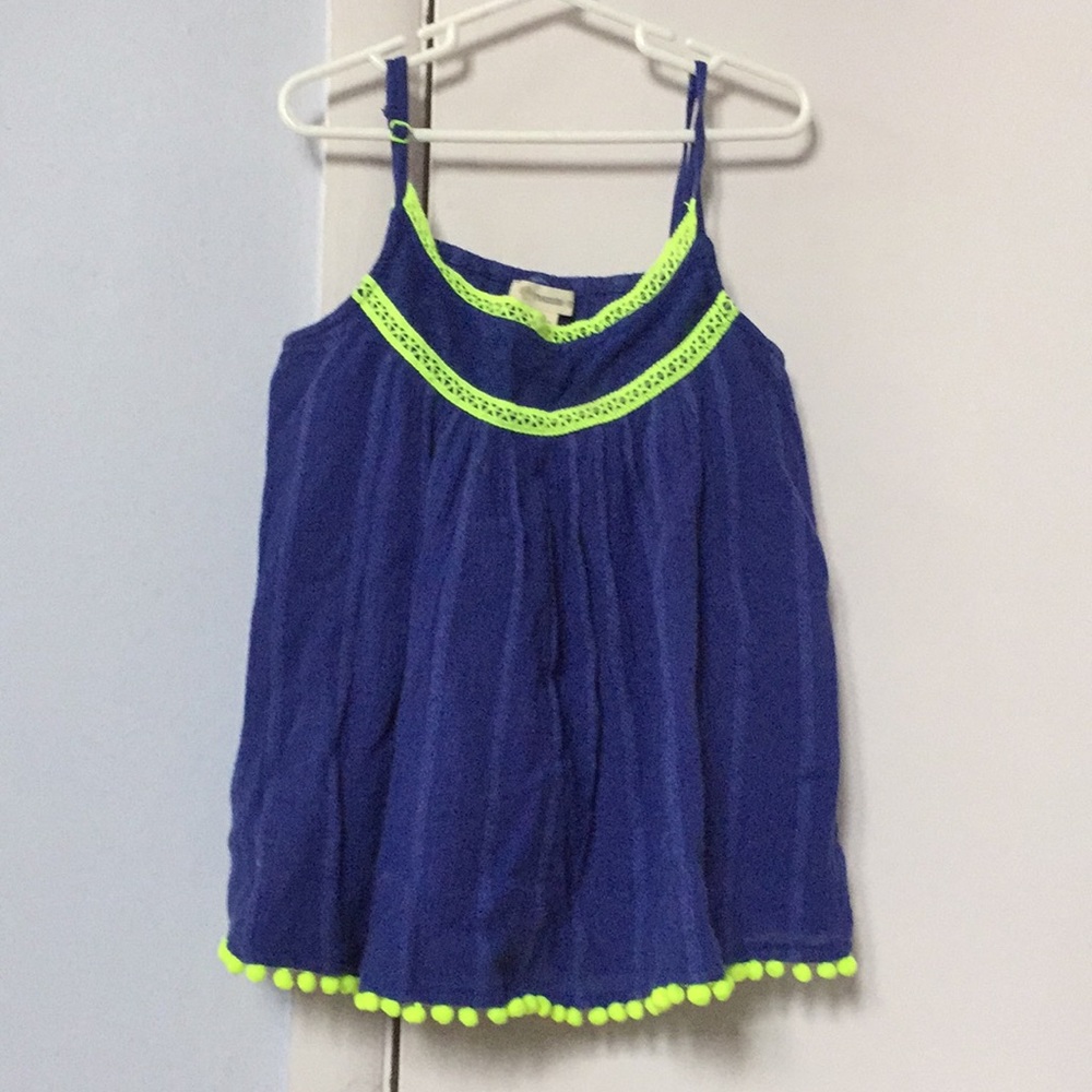A tank top with puff balls at the end